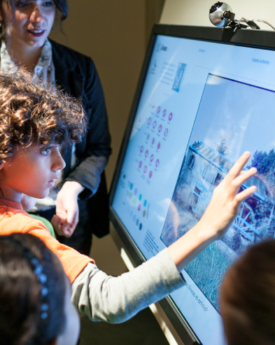 child working on screen monitor